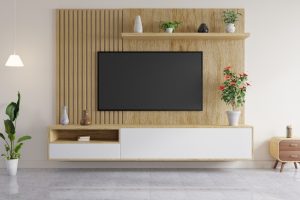 Modern living room with a wooden accent wall featuring various wall panel thicknesses, a mounted flat-screen TV, floating shelf with decorative items, and minimalist furniture showcasing the impact of wall panel thickness on room aesthetics.