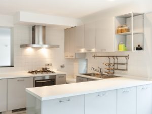 Modern kitchen cupboard designs with white cabinets, sleek stainless steel appliances, and a minimalist layout.